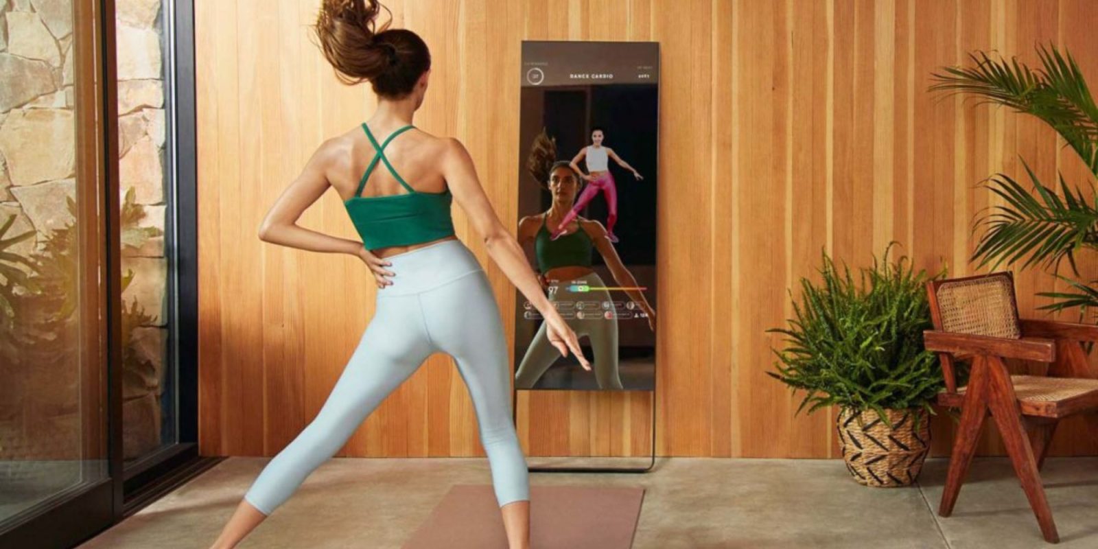 person working out in front of a smart mirror
