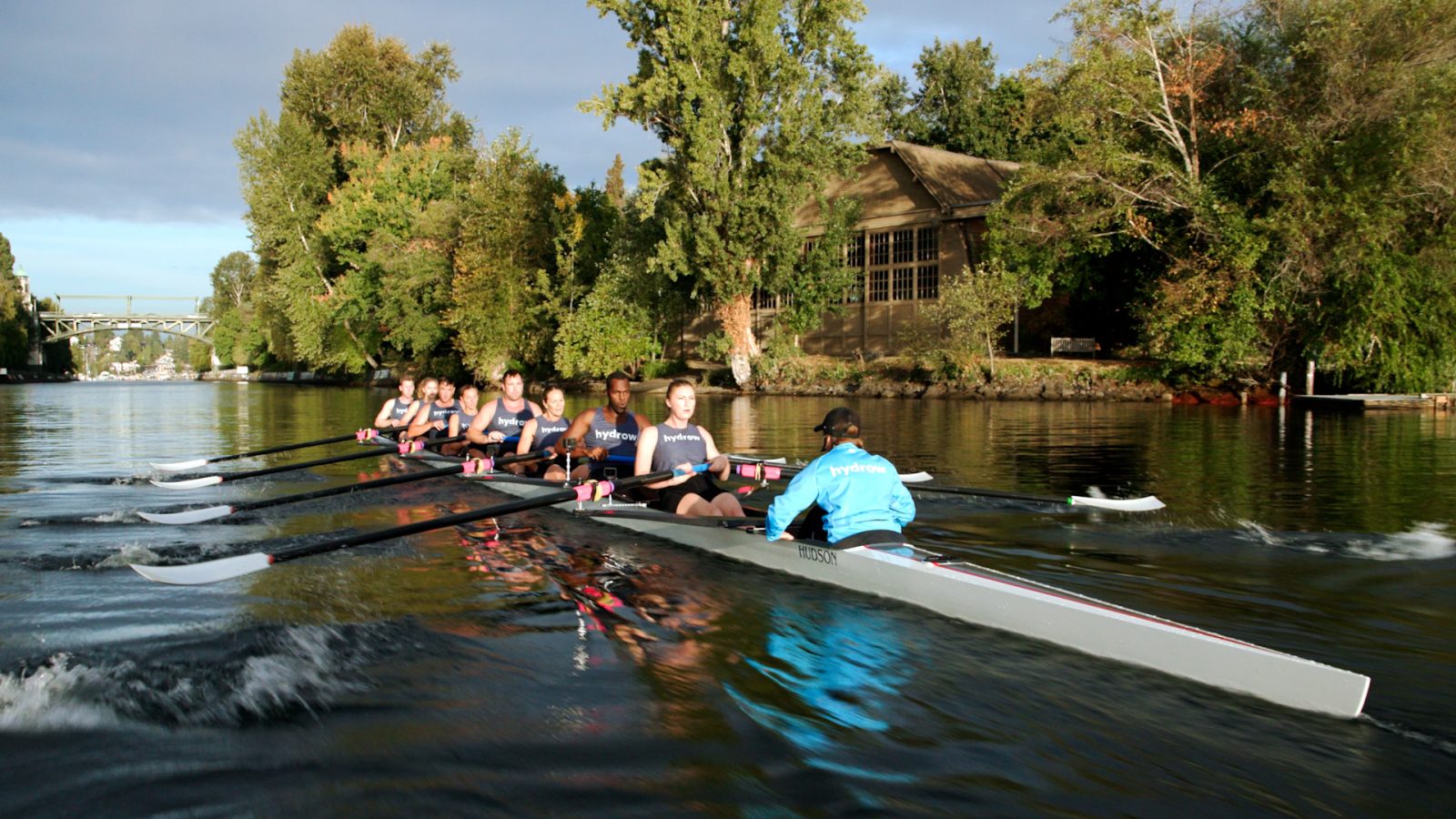 a group of people rowing a boat in the water