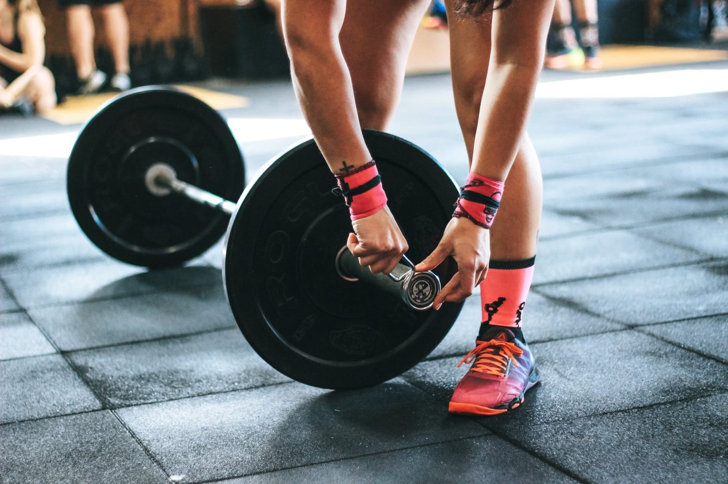 person holding black barbell