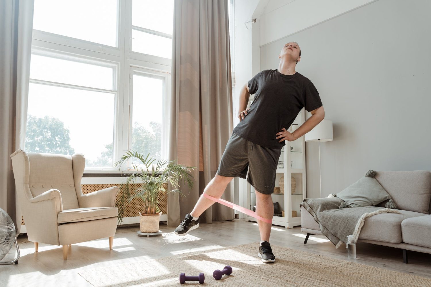 man using resistance band while looking up