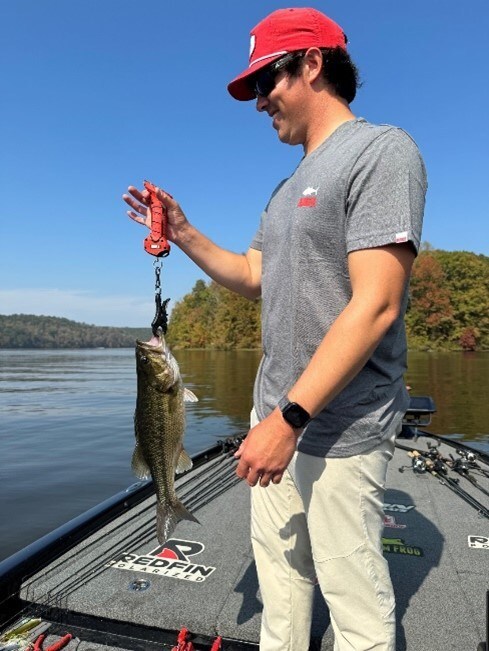 a man holding a fish on a boat