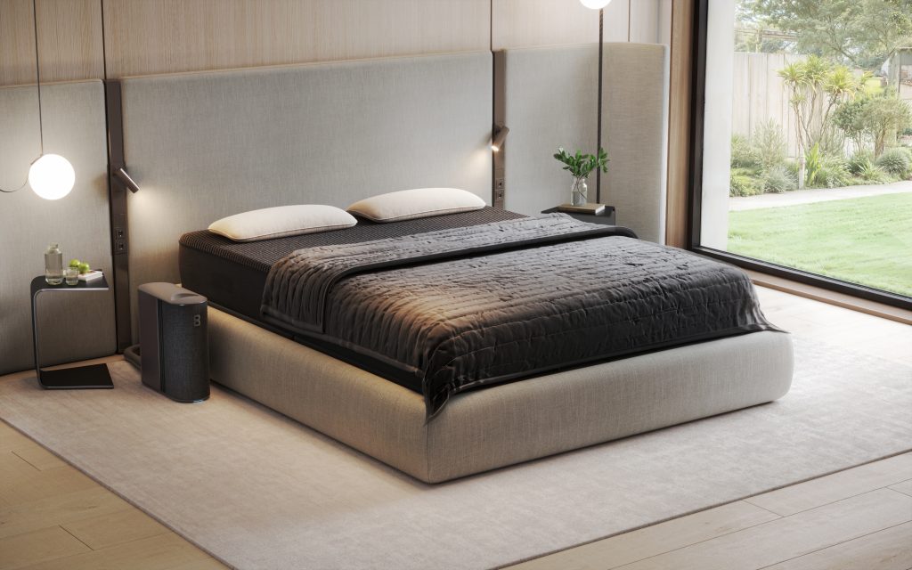 A bed with a headboard and a lamp