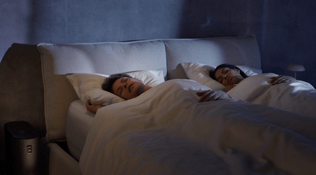 A man and woman sleeping in bed