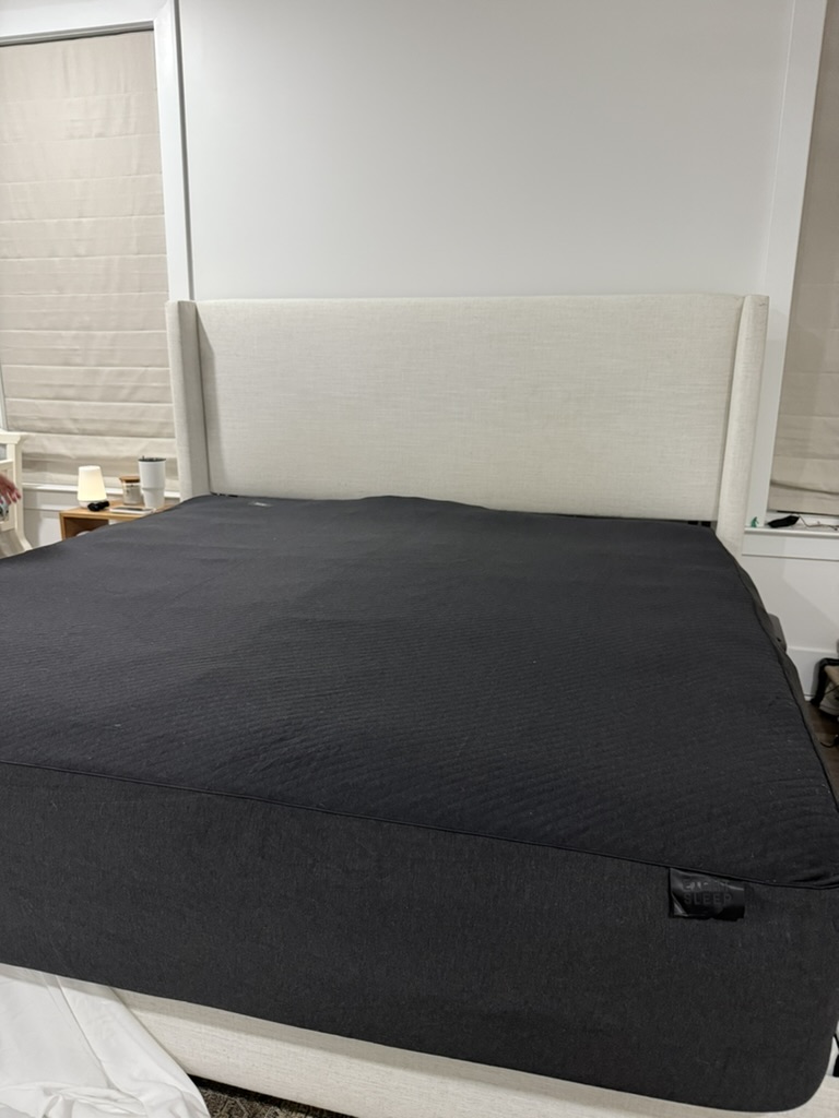 A bed with a black cover