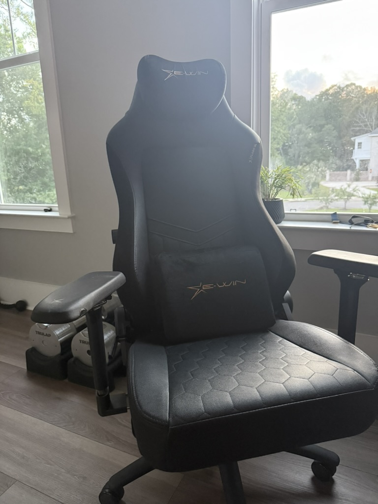 A black gaming chair in a room