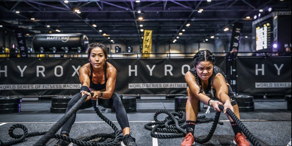Two women working out with ropes