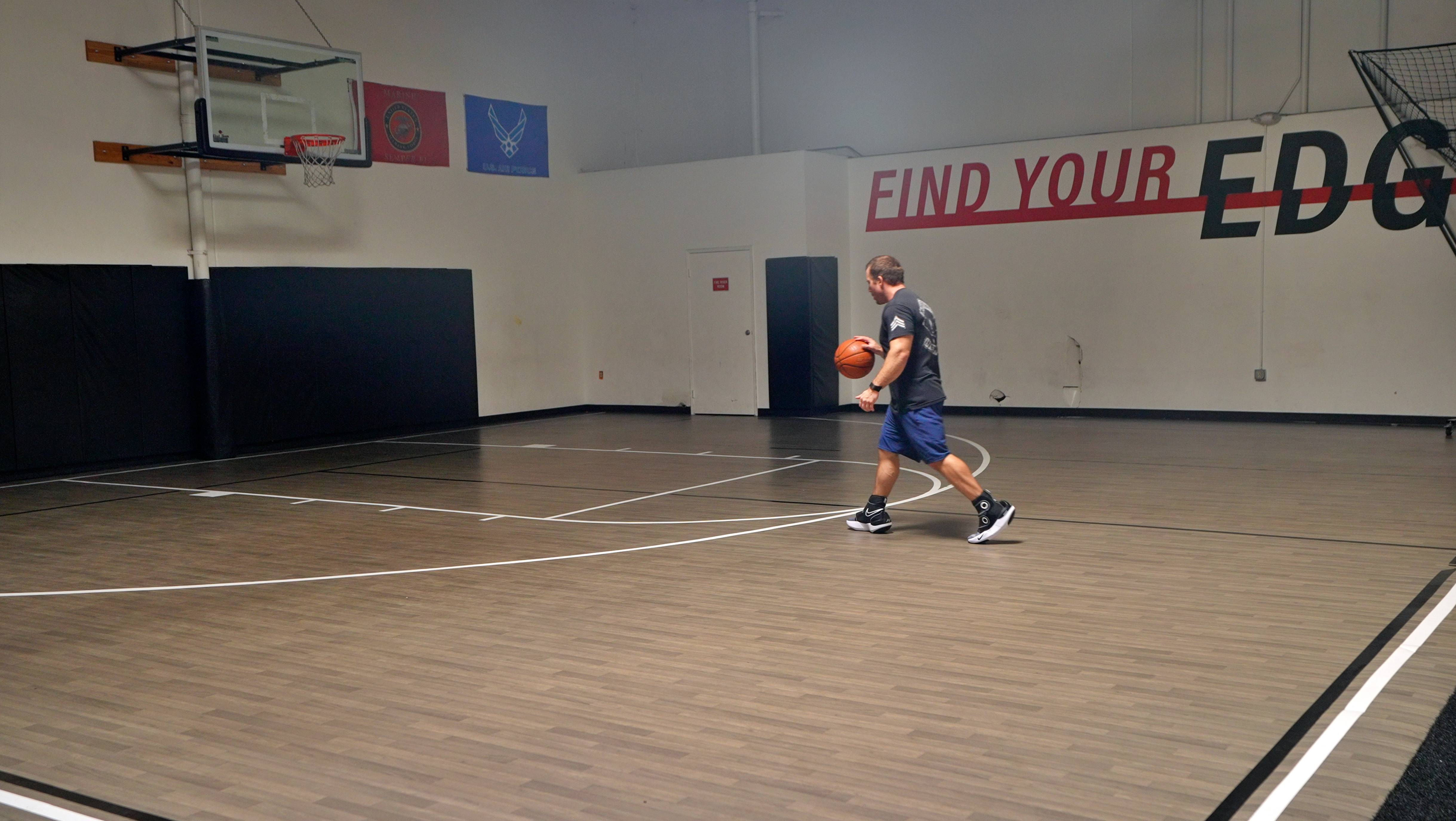 A man holding a basketball in a gym